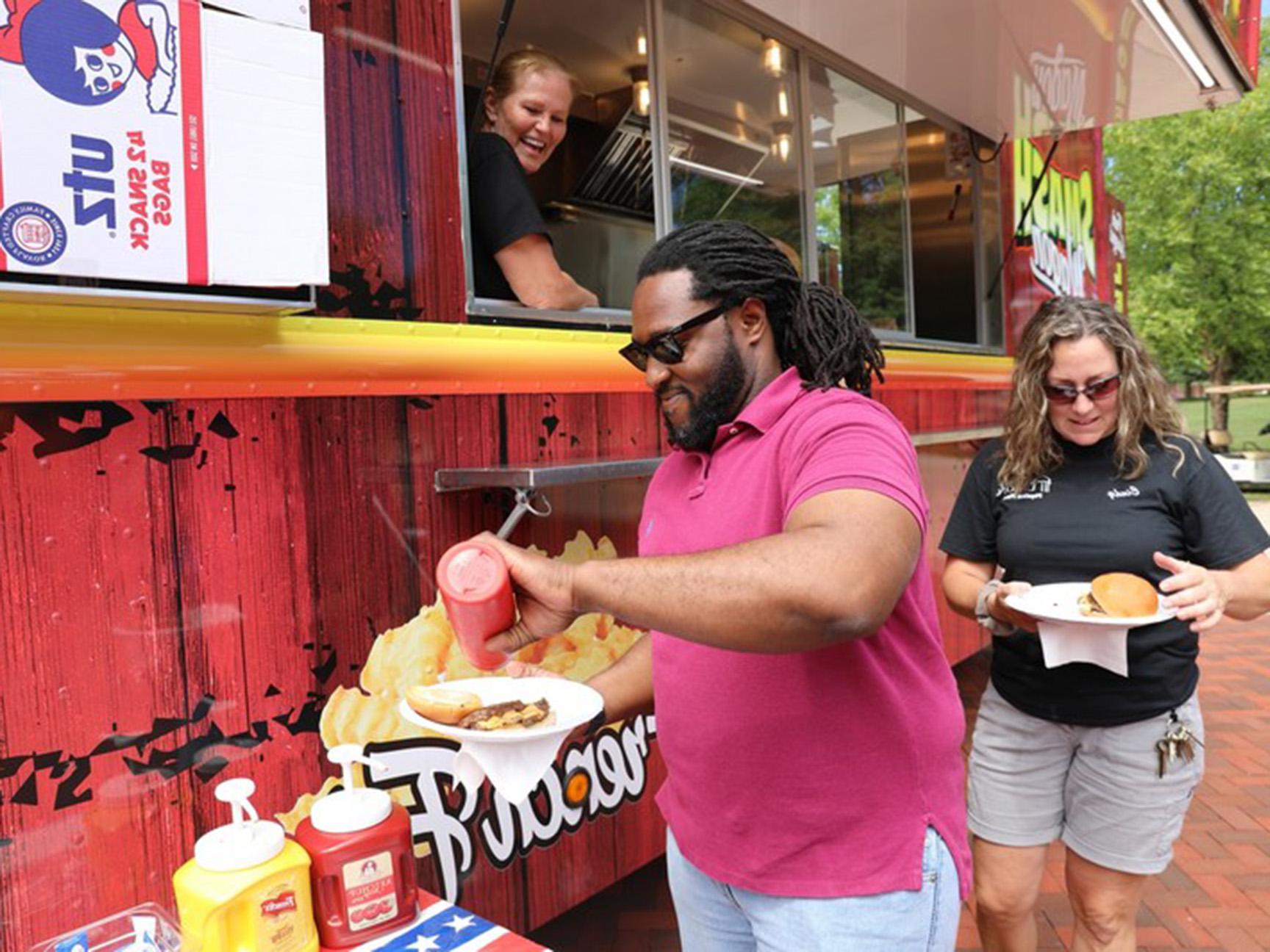 Staff members enjoying a food truck on campus